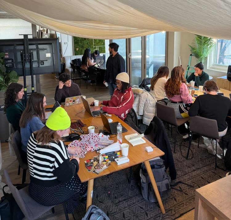 Members coworking under a canopy at a Creative Coffee Club meetup in New York
